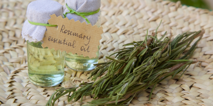 rosemary dried herb next to clear glass container of oil