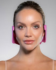 front facing woman model wearing pink Miss Careful ear covers