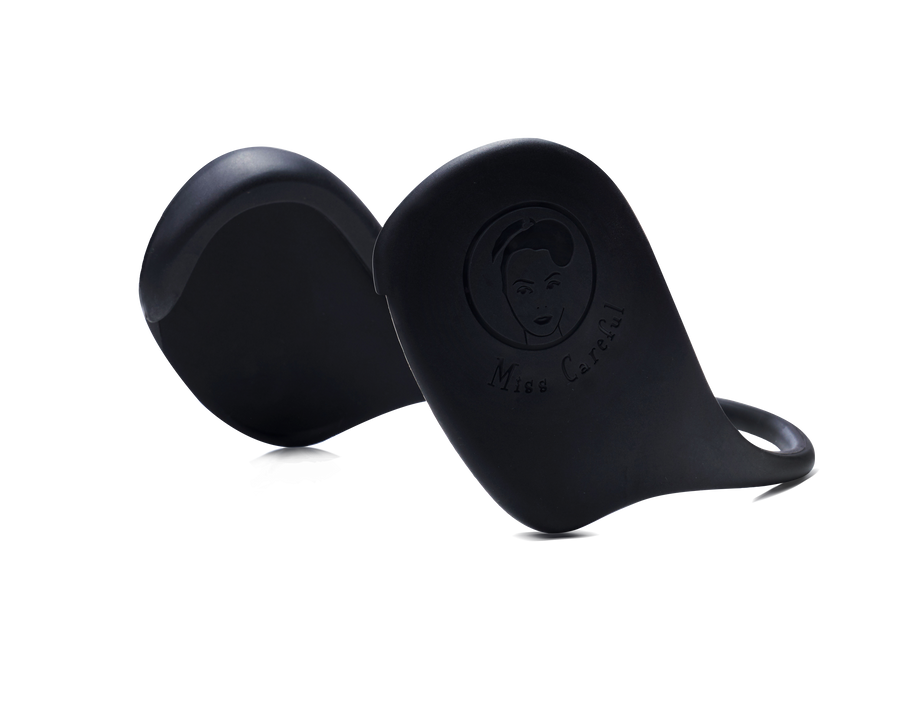 Black variant of Miss Careful brand Ear Covers to help protect ears from hot tools and dyes. Close up showing plain black color and Miss Careful logo on the ear covers.