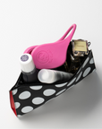 Miss Careful Pink color ear covers in a purse with perfume and other feminine products.