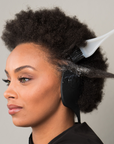 Woman getting her hair colored while wearing ear protectors