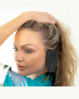 Woman wearing black color variant of Miss Careful Ear Covers on her ears - side view