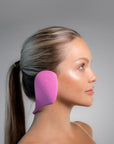 Side view of a white woman wearing pink color Miss Careful brand of Ear Covers on her ears