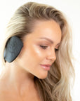 Close up of a woman profile view wearing black color Miss Careful brand of Ear Covers